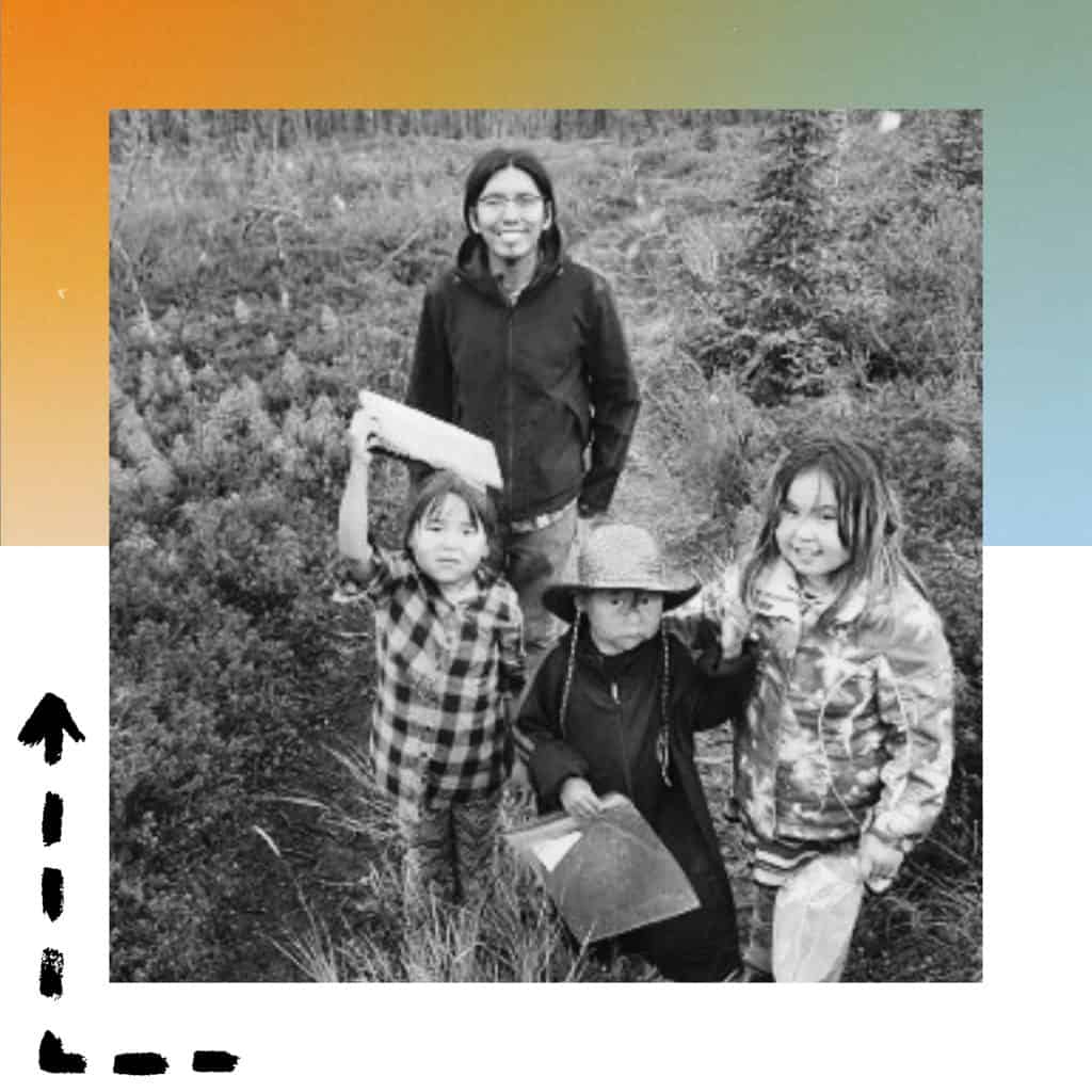 Photo of a group of three young kids and an adult smiling together - they are enjoying salmon camp!