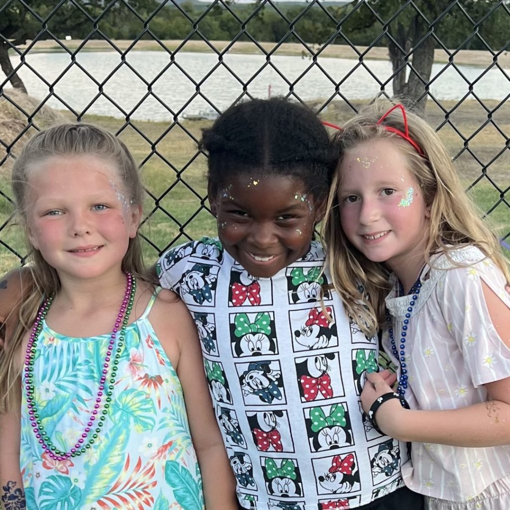 three girls smiling together