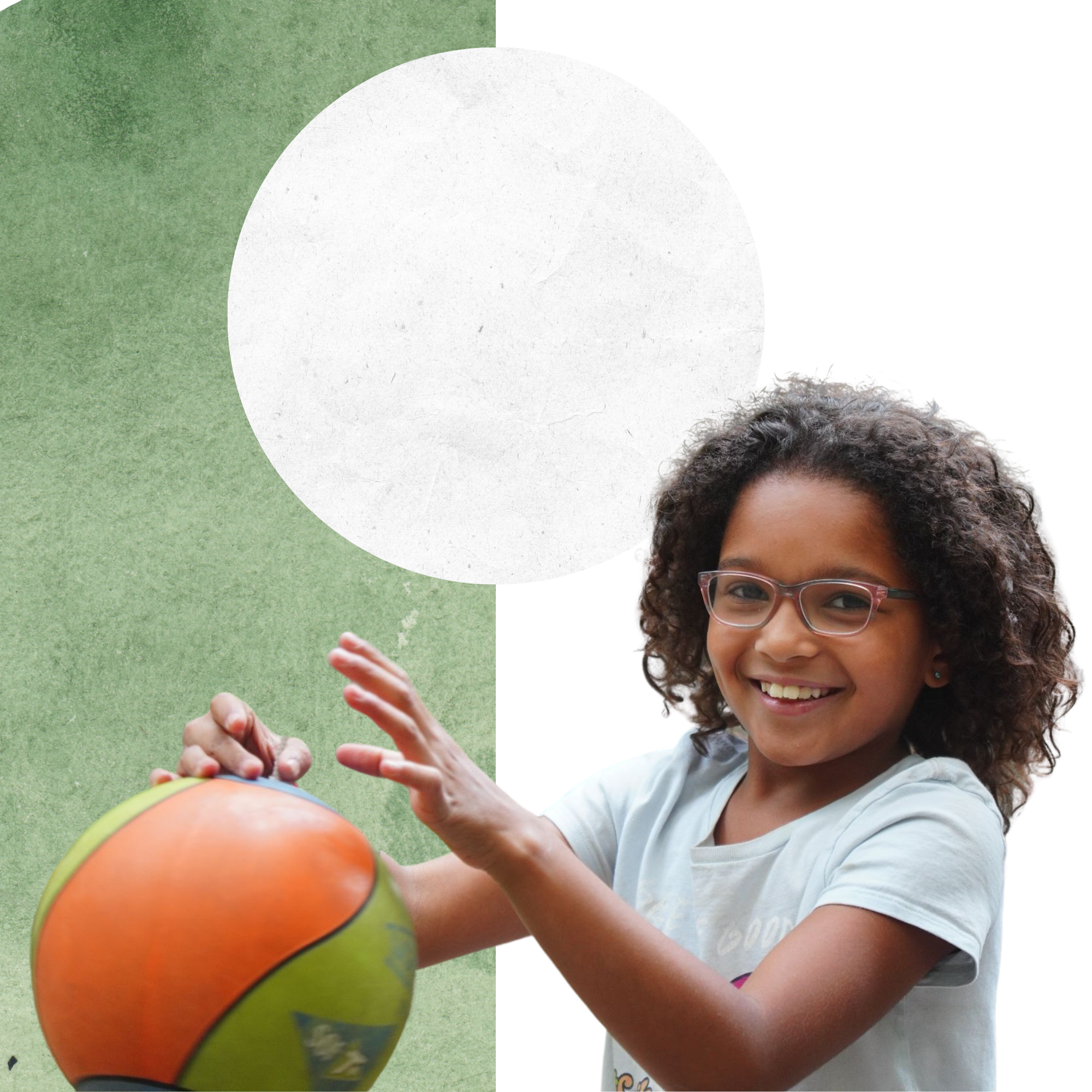 girl smiling at camera while playing tetherball